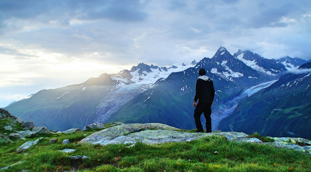 person climbing mountain success