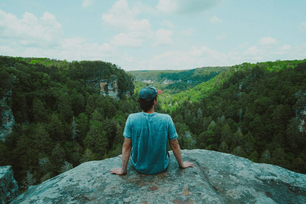 person meditating in nature