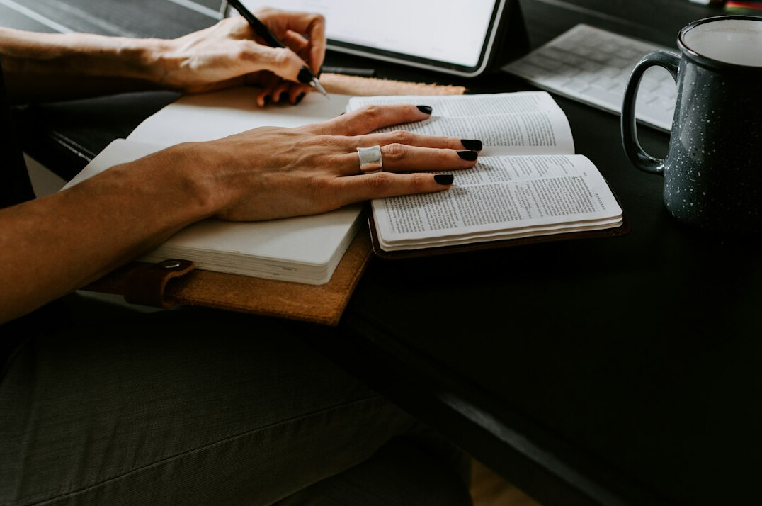 person writing goals in journal